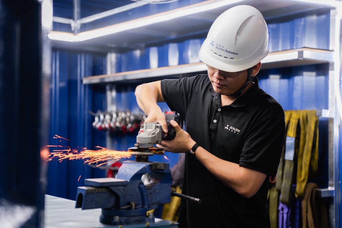 SeAlien technician preparing a component in the manufacturer's workshop