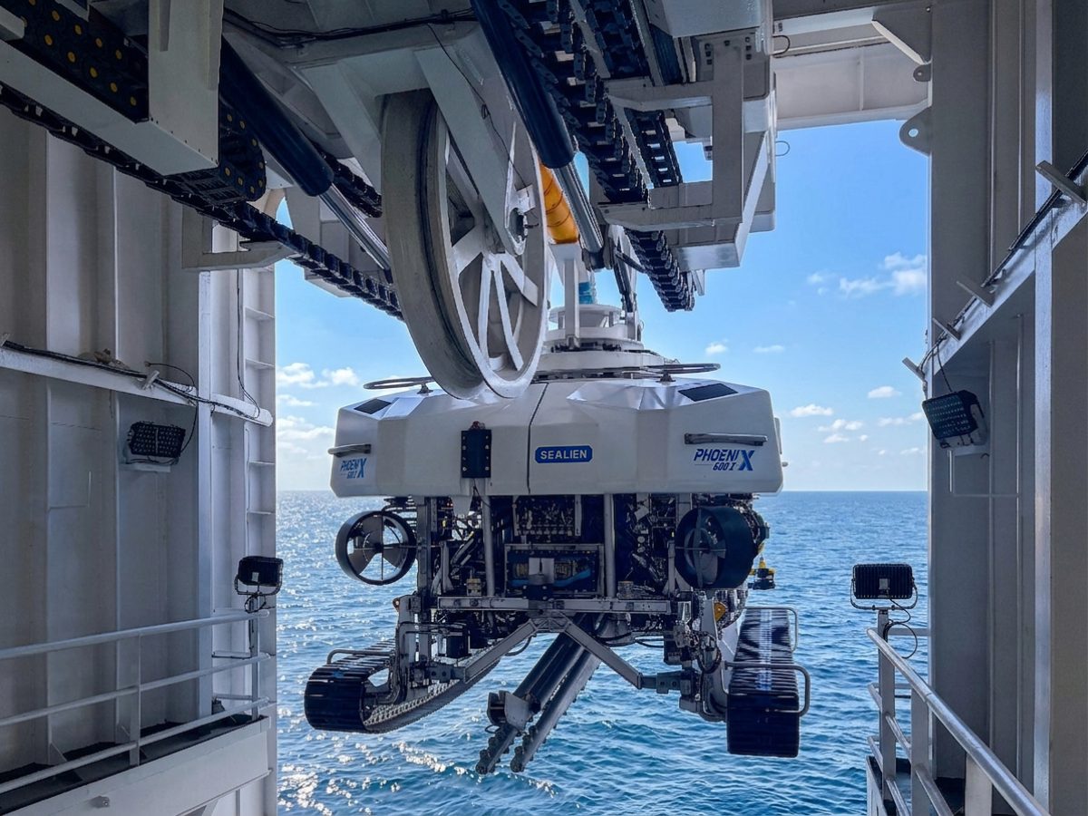 Phoenix 600 trenching ROV suspended above the sea in its vessel launch system